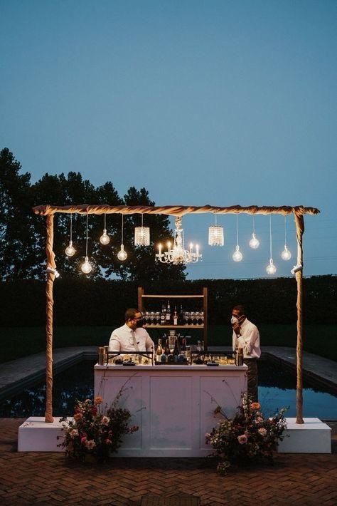 Outdoor bar with hanging lights poolside