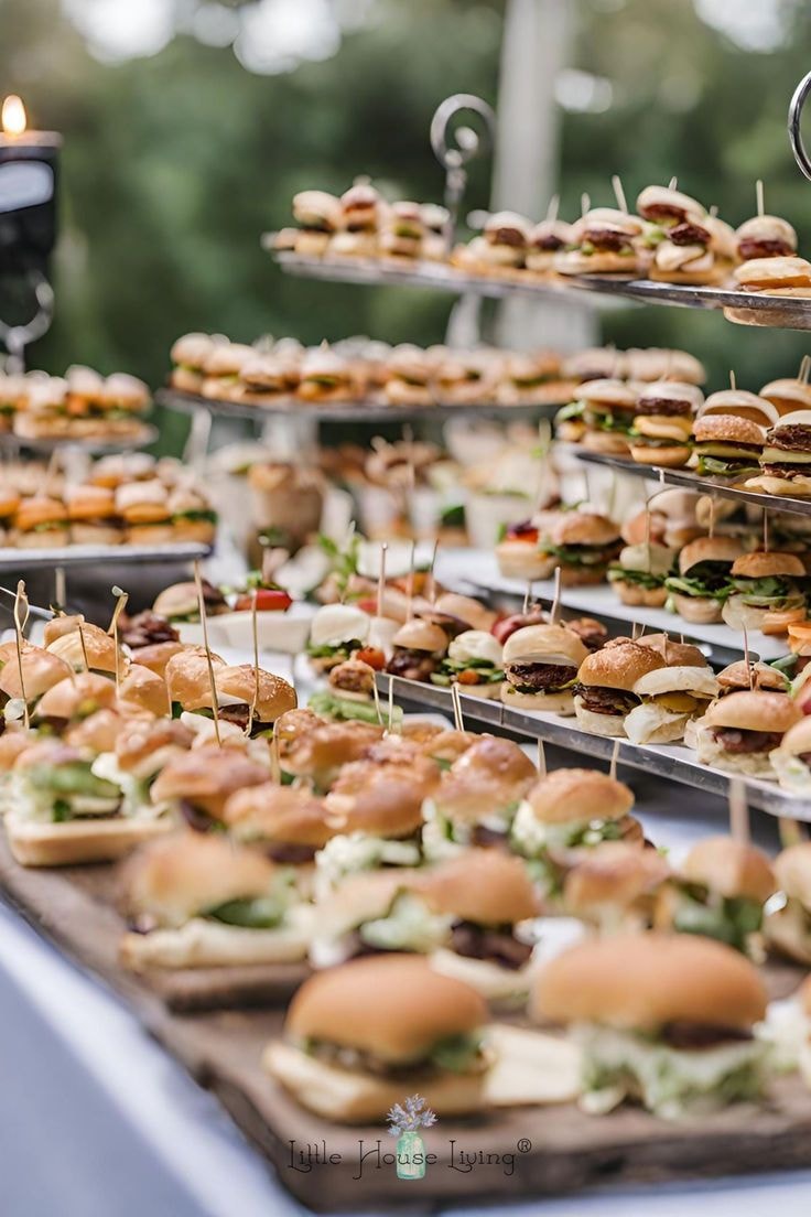 Mini sliders on tiered display at outdoor event