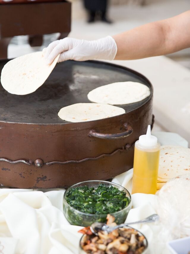 Hand-pressed fresh tortillas on comal